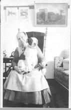 SA0120 - Photograph of an unidentified Shaker woman seated and with dog in her lap.